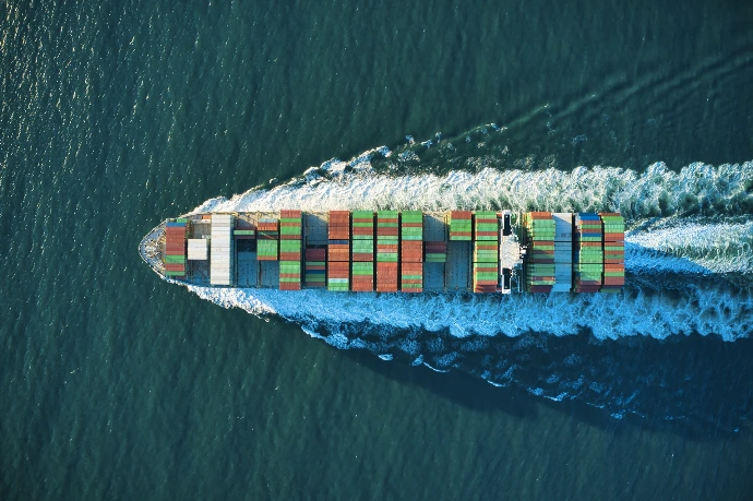 aerial view of blue and white boat on body of water during daytime