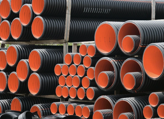 a pile of red and black pipes stacked on top of each other